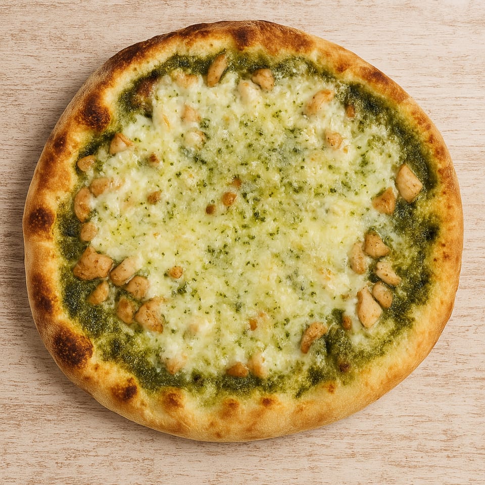 Roma Pizza's pesto chicken pizza with melted mozzarella cheese on a light wooden surface.