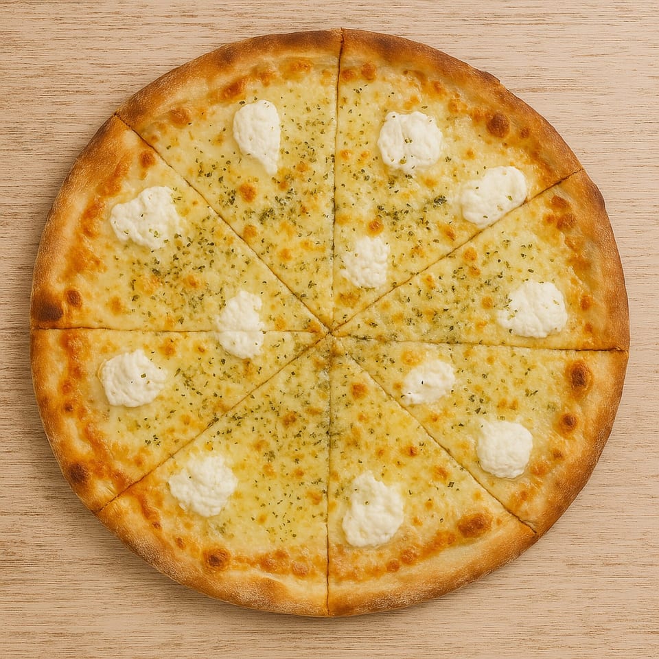 A sliced Roma Pizza with white cheese, herbs, and dollops of ricotta on a wooden table.